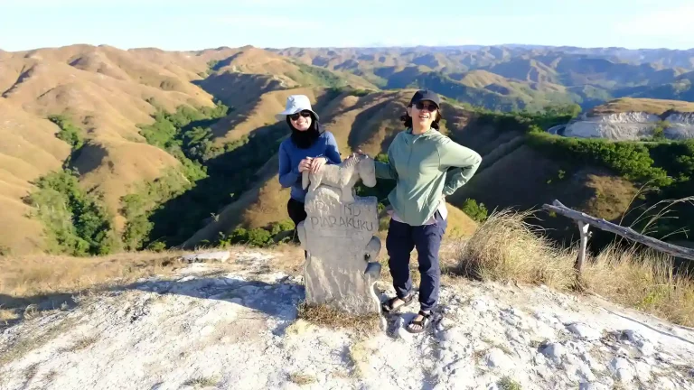 Two travellers at the Piarakuku Hills viewpoint, East Sumba