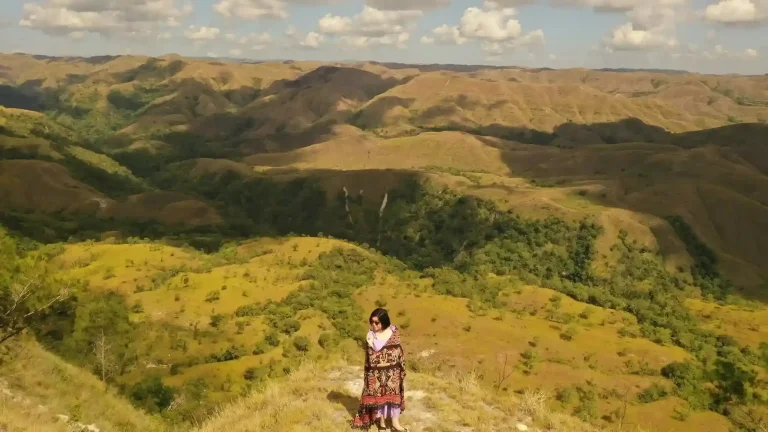 Traveller in ikat cloth on the Tanarara Hills, East Sumba