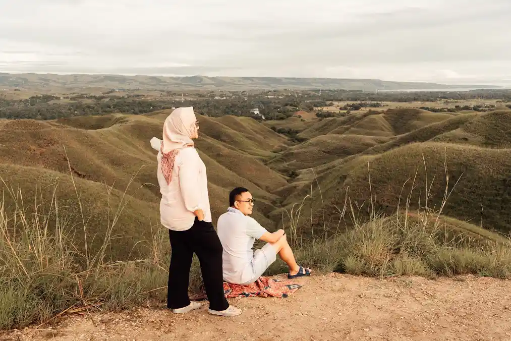 Travellers overlooking the dry-season hills of Tanau, East Sumba