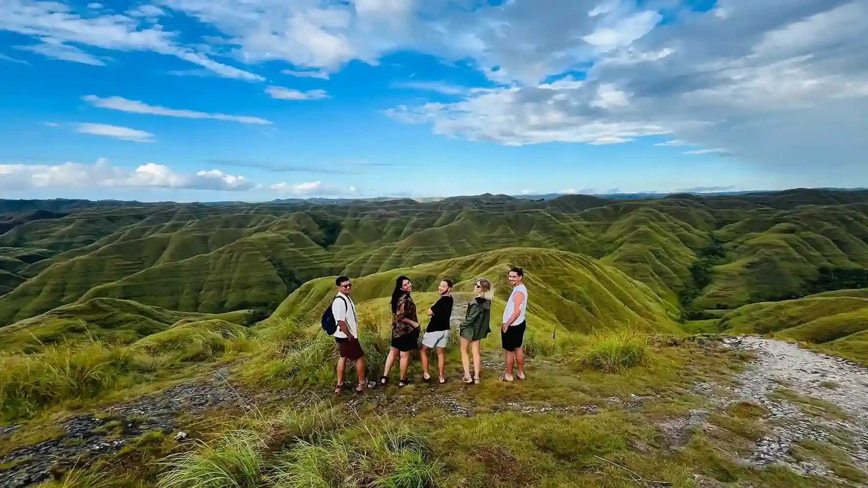Travellers on the green hills of Sumba