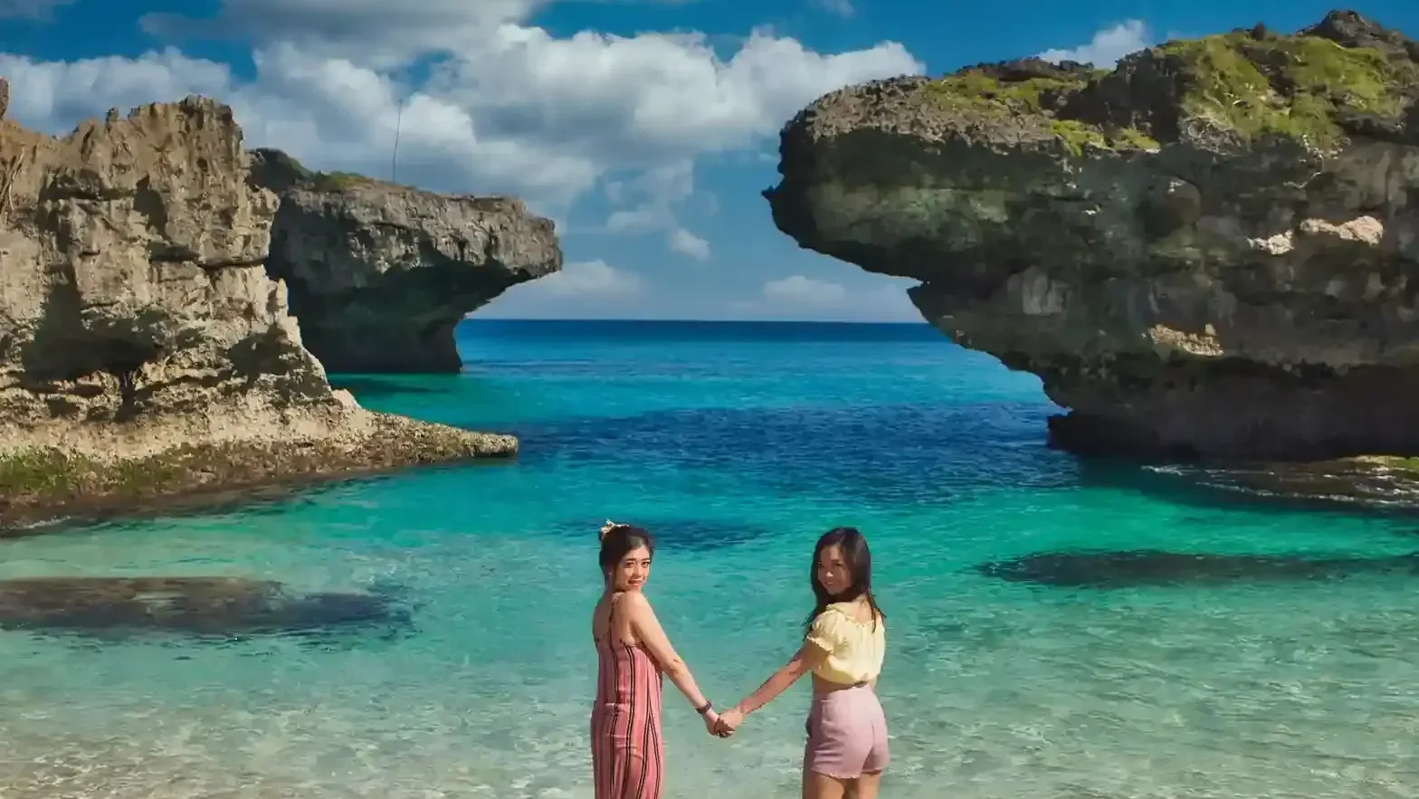 Two travellers in the turquoise water of Mandorak Beach, Southwest Sumba