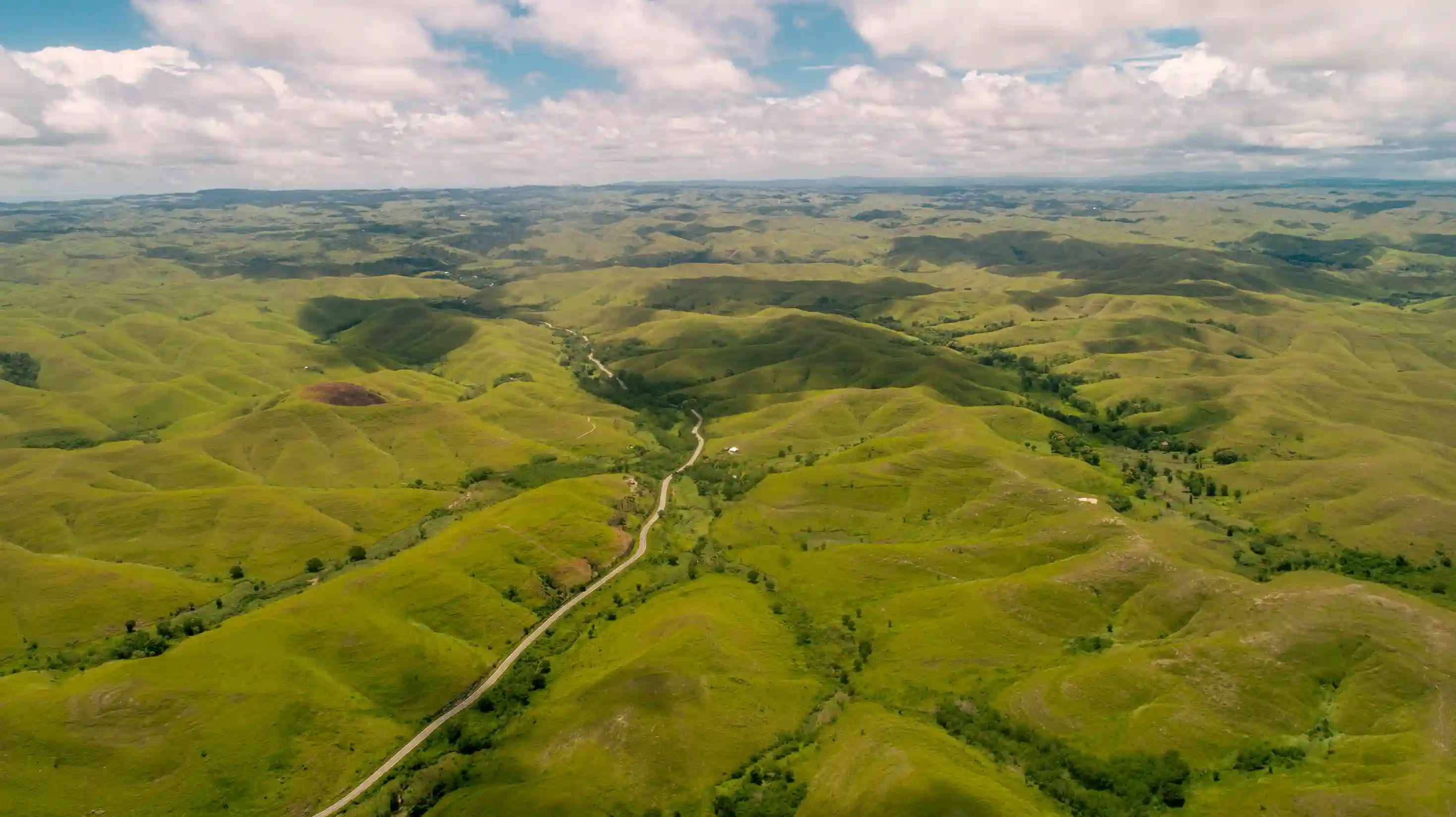 Aerial view of the open green hills of Tanau, East Sumba